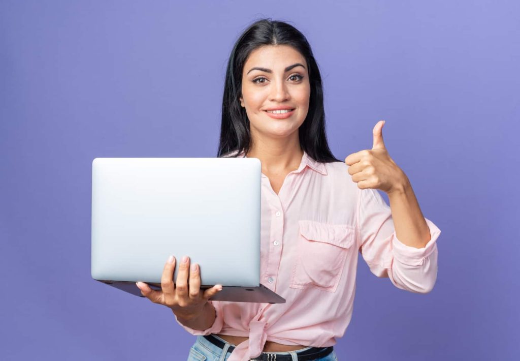 Girl showing OK with thumb and holding laptop, highlighting fast and secure eSign services